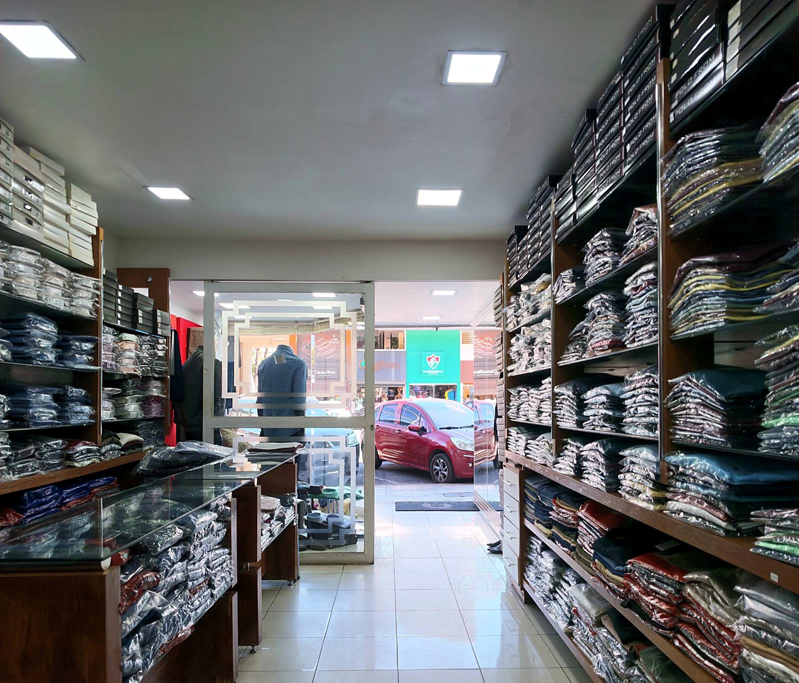 Corredor da Everton Moda Masculina com o acervo de camisas e calças dos dois lados